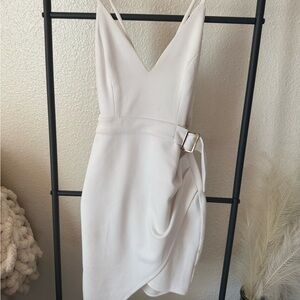 White bodycon dress with belt, and side slit.